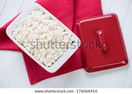 Glass dish with fresh cottage cheese, view from above