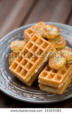 Vertical shot of freshly made waffles served with fried banana