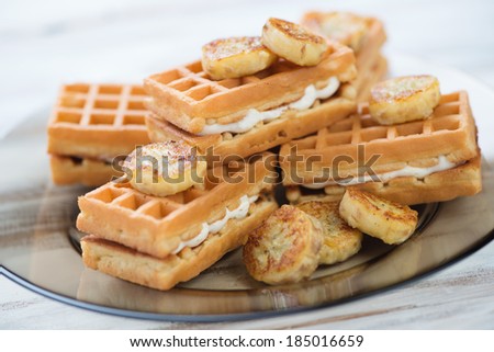 Waffles with slices of grilled banana, close-up, studio shot
