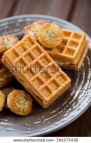 Close-up of waffles with fried banana, vertical shot
