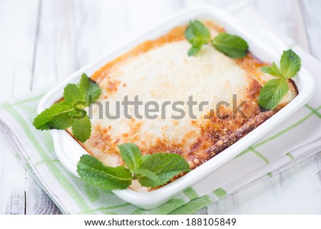 Freshly made vegetarian lasagna with mint leaves, studio shot
