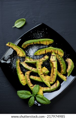 Grilled avocado slices with sea salt, close-up, above view