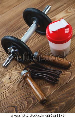 Protein shake with various sports equipment, high angle view