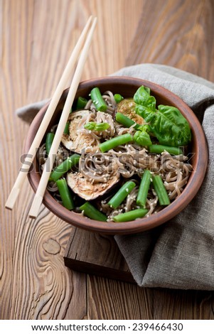 Soba noodles with aubergine slices, beans and sesame seeds