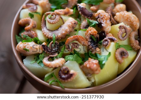Italian salad with sliced octopus, potato and parsley, close-up