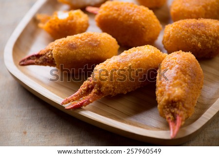 Bamboo tray with breaded crab claws, close-up, selective focus