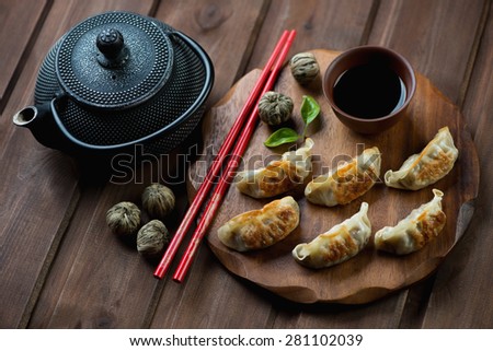 Traditional asian pan fried gyoza dumplings with a dip sauce