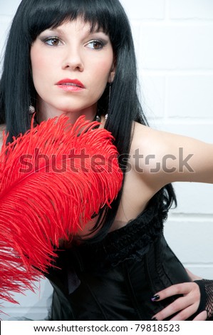 Beautiful black-haired woman with a red feather