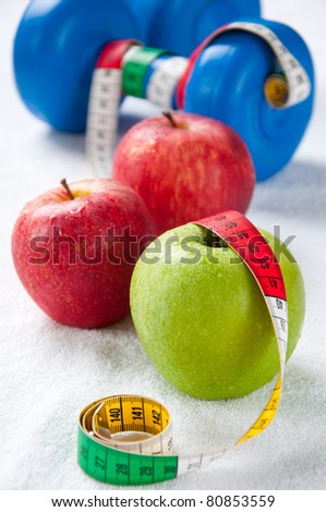 Fresh apples, tape-line and dumbbells. Healthy life-style