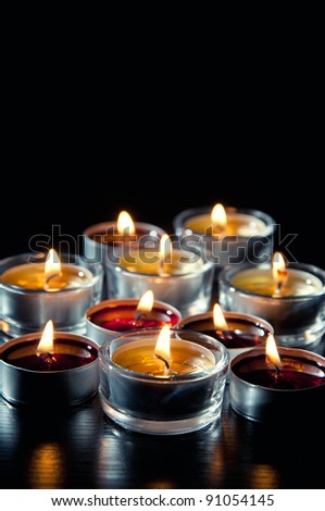 Burning tea light candles in the dark