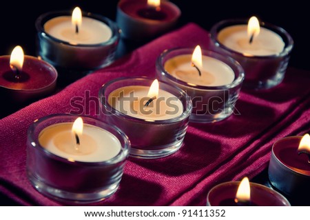 Burning tea light candles, close-up