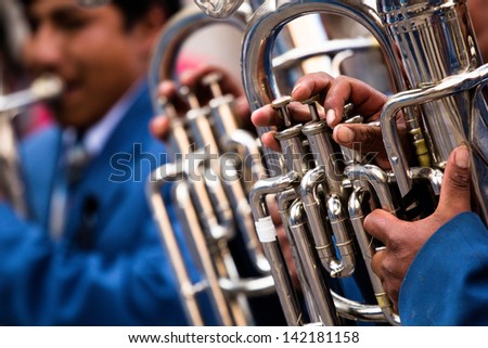 Trombones playing in a big band.