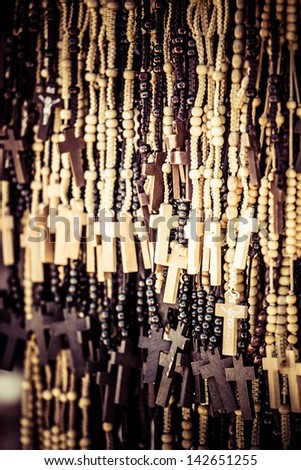 Wood made crosses for sale on colorful background