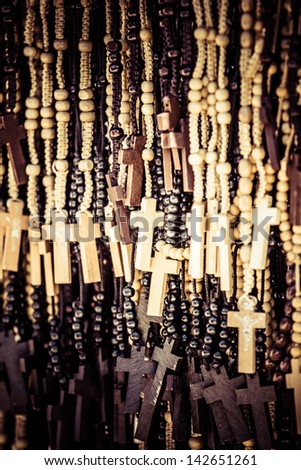 Wood made crosses for sale on colorful background