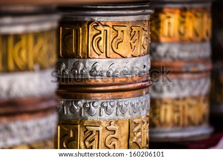 Buddhist prayer wheels in Tibetan monastery with written mantra. India, Himalaya, Ladakh