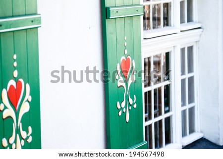 Typical germany windows with green shutters and window box