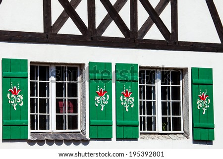 Typical germany windows with green shutters and window box