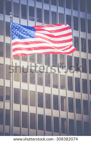 American flag waving in the breeze in the Chicago downtown loop business district.