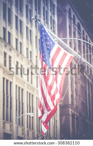 American flag waving in the breeze in the Chicago downtown loop business district.