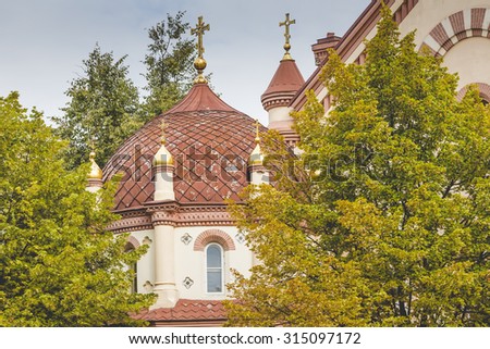 Domes of Our Lady of the Sign Church, the orthodox church between trees in Vilnius, Lithuania
