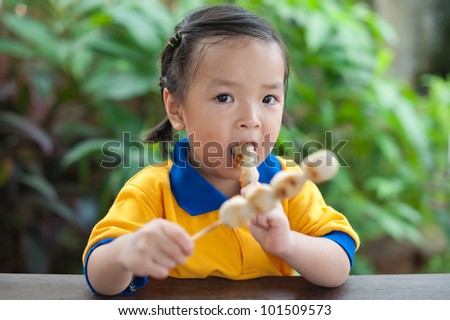 Little girl eating meat balls