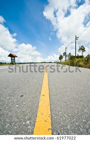 yellow line on road and blue sky
