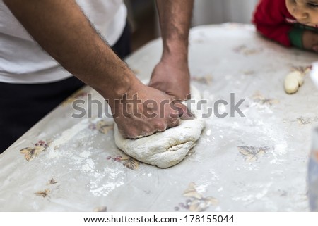 Baker making bread, man hands, kneading dough, cooking coat
