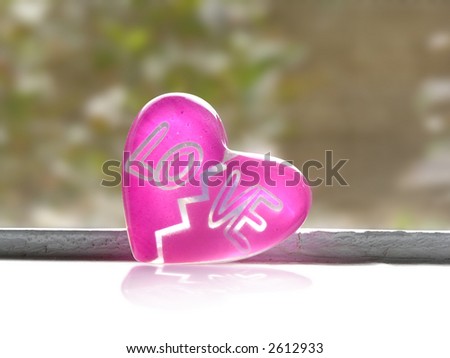 Pink glass transparent heart on a window with clipping path for the heart