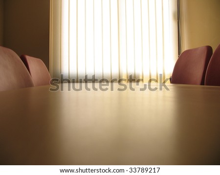 Red chairs in a meeting room and window with curtains
