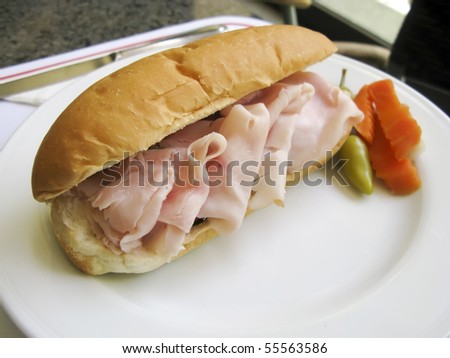 Smoked salmon sandwich with carrot, pepper and lemon pickles on white plate
