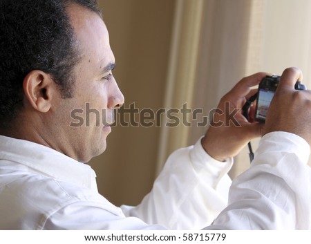 Middle eastern man shooting with point and shoot camera