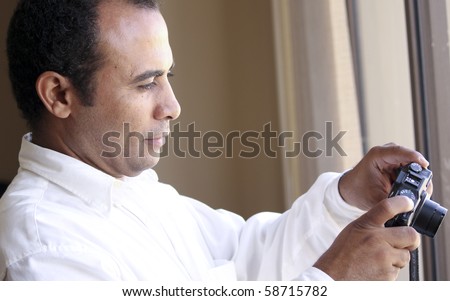 Middle eastern man shooting with point and shoot camera