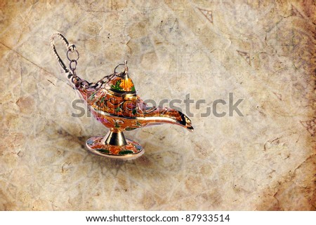 Colorful genie lamp also called Aladdin lamp on grungy background with geometric ornaments halftones