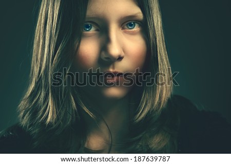 Dark portrait of a teen girl, closeup