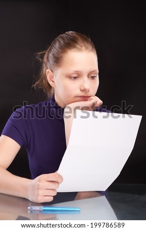 Sad, depressed teen girl readng letter