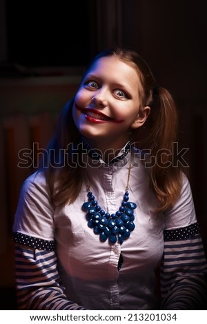 Clown teen girl with a sinister smile
