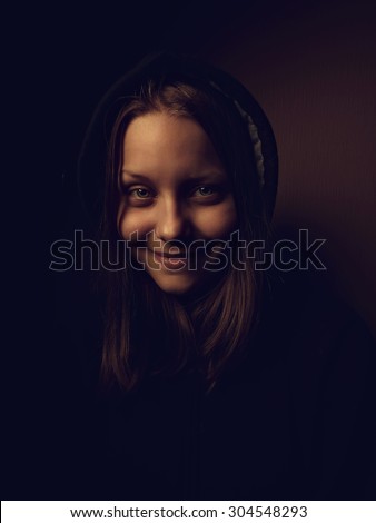 Portrait of a devil teen girl with a sinister smile, closeup