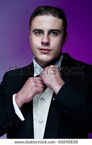 Portrait of young handsome groom in suit