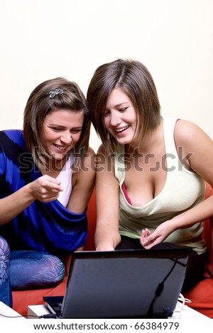 Group of young people around laptop