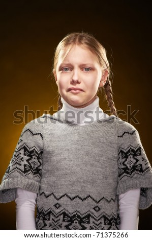 Crying little girl with displeased face