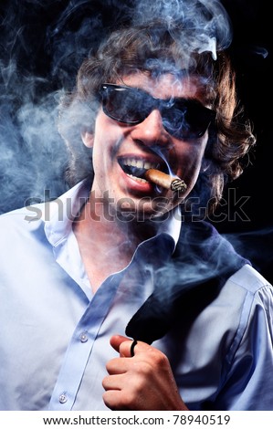Closeup portrait of a smoking man with cigar