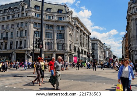 LONDON - JULY 1, 2014: Oxford Circus with unidentified people in London. Up to over 40.000 pedestrians per hour pass the junction, it is the highest pedestrian volumes recorded in London.