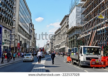 LONDON, UK - JULY 1, 2014: Busy Oxford street in London. It is the the biggest shopping street in Europe, visited by millions of tourists.