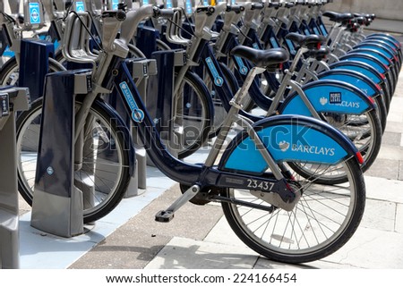 LONDON, ENGLAND - JULY 1, 2014: Shared bikes are lined up in the streets of London. Barclays Cycle Hires, launched in July 2010, has over 720 stations and 10,000 bikes throughout London.