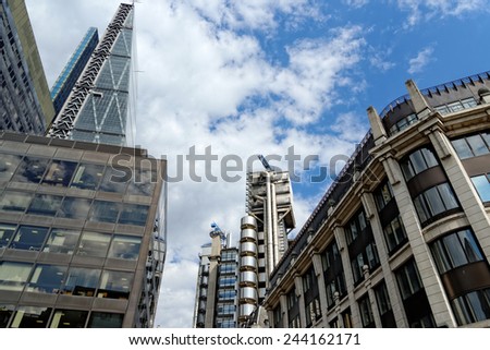 LONDON, UK - JULY 1, 2014: The famous office buildings - The Cheesegrater (Leadenhall Building) and the Lloyd's Building in the City of London, one of the leading centers of global finance.