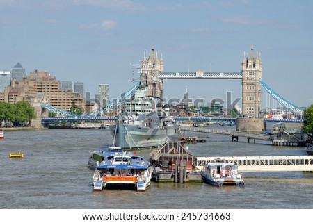 LONDON, UNITED KINGDOM - JULY 1, 2014: A City Cruises tour boat sails on the Thames River near Tower bridge. Thames is the longest river in England with 346 km (215 miles) long.
