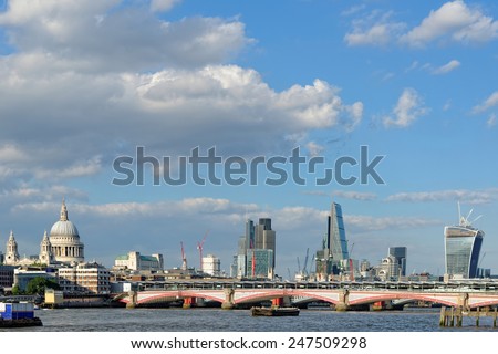 A view of Blackfriars bridge -  a road and foot traffic bridge, over the river Thames against a background of St Paul Cathedral, the City and the Blackfriars railway bridge.