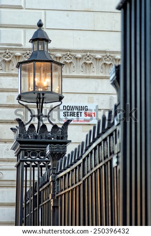LONDON, UK - JULY 1, 2014: Downing Street\'s sign in the City of Westminster. Downing St. has housed government leaders for over three hundred years.