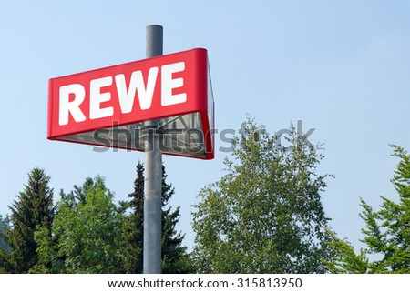 PEITING, GERMANY - AUGUST 11, 2015: The logo of the REWE supermarket, part of the REWE Group - a German retail and tourism group, operating in 14 European countries.