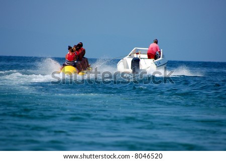 Young people enjoying a ride on a banana boat